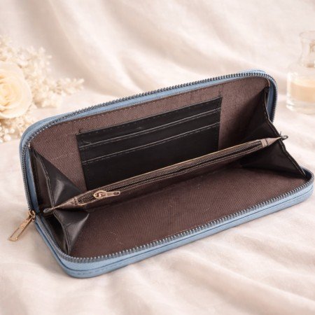 Dusty blue textured zip around wallet for women with metal logo plate detail