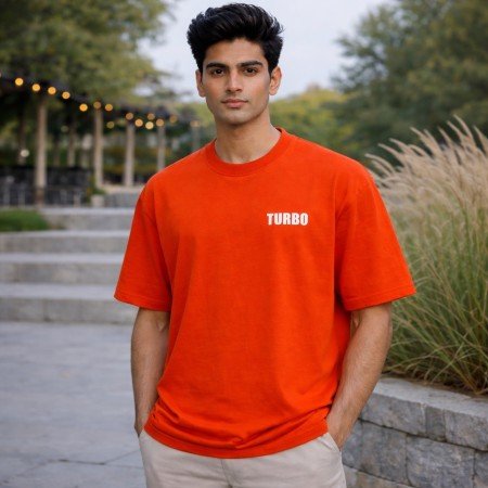 Men's orange oversized 100% cotton crew neck T-shirt with minimal chest graphic and relaxed casual fit front view.