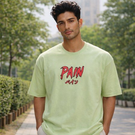 Female model wearing unisex sage green oversized cotton T-shirt featuring Naruto Pain anime graphic print on front.