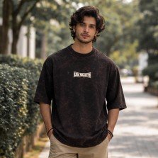 Men washed black oversized crew neck graphic t-shirt with text print on front, front view