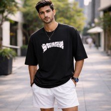Male model wearing unisex black oversized Naruto anime cotton T-shirt with Itachi and Sasuke graphic front print.