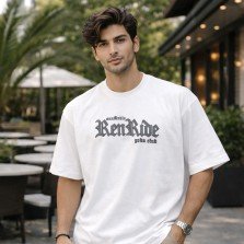 Male model wearing a white oversized anime graphic t-shirt with front text print and casual oversized styling.
