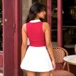 Back view of women's berry pink ribbed sleeveless polo knit top with contrast white polo collar.
