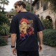 Male model displaying the back design of a black Jujutsu Kaisen graphic t-shirt featuring bold Yuji Itadori artwork and anime-inspired streetwear design