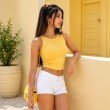 Model wearing a butter yellow cotton ribbed tank top styled with denim shorts