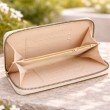 Interior of beige long wallet for women featuring card slots and central zip coin compartment
