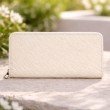 Back side of beige zip around wallet for women in woven textured pattern