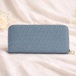 Back side of dusty blue women’s zip around wallet in woven textured finish