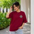 Female model wearing a maroon One Piece oversized anime t-shirt with a chest logo graphic and casual oversized silhouette