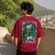 Male model showcasing the back of a maroon One Piece graphic t-shirt featuring Roronoa Zoro artwork with a green dragon-inspired anime design.