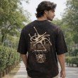 Men washed black oversized crew neck graphic t-shirt with text print on front, back view