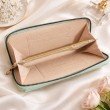 Interior of mint green long wallet for women featuring card slots and central zip coin pocket