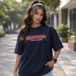 Female model wearing a dark blue Kakashi Hatake oversized anime t-shirt with a relaxed streetwear fit