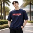 Male model wearing a dark blue Naruto oversized t-shirt featuring Kakashi Hatake-inspired front graphic artwork