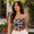 Women's geometric print tube top featuring an artisan-inspired woven pattern and strapless neckline.