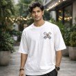 Male model wearing a white One Piece oversized t-shirt with Straw Hat pirate emblem on the chest
