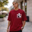 Front view red oversized anime T-shirt with Light Yagami Death Note print unisex fit worn by male model