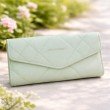 Sage green quilted long wallet for women with flap closure and gold logo detail