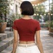 Back view of women's red ribbed cotton jersey crop top featuring stretch fabric, short sleeves and lettuce trim hem.