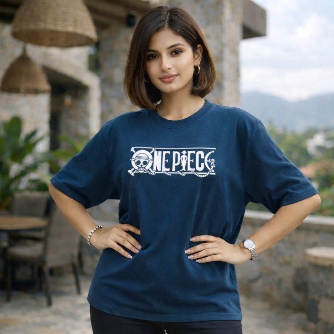 Female model wearing a navy blue oversized One Piece anime t-shirt with front logo artwork and relaxed streetwear styling.